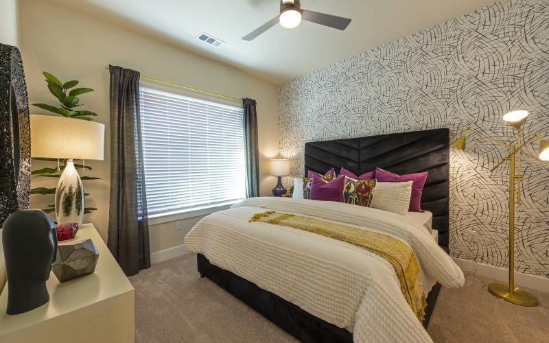 a bedroom with a bed and lamps