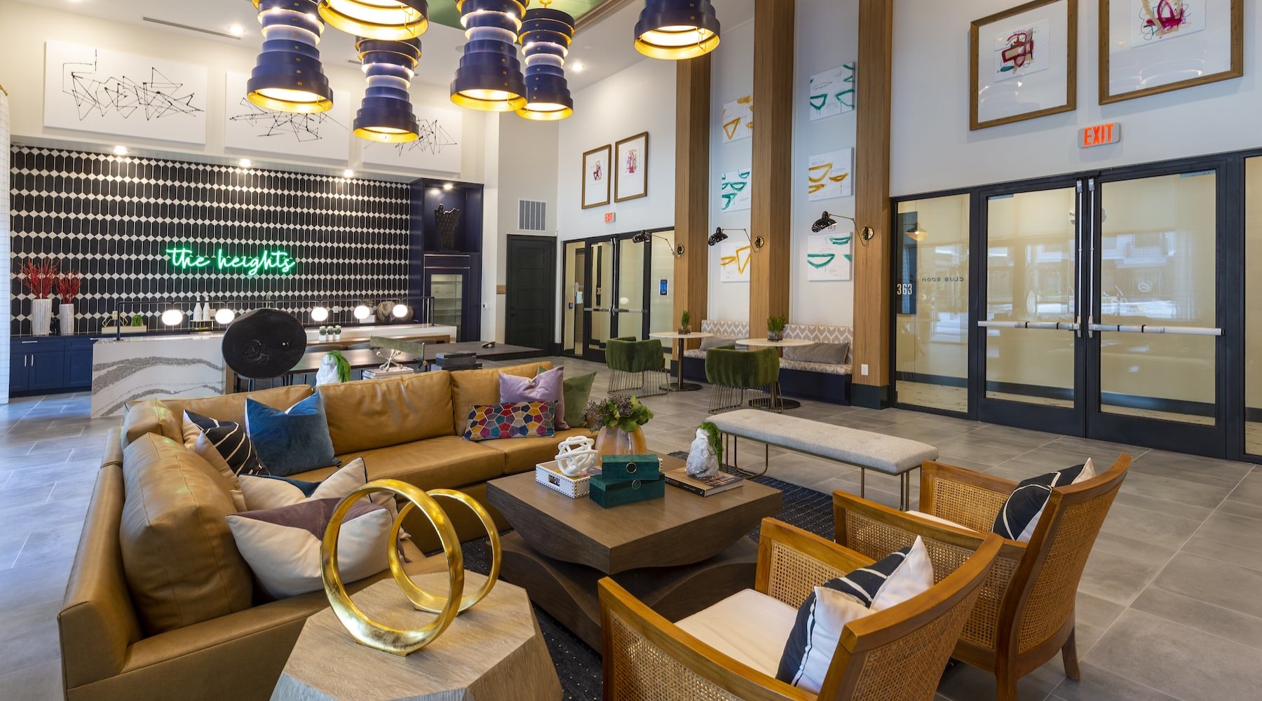 a clubroom with a couch, tables and chairs