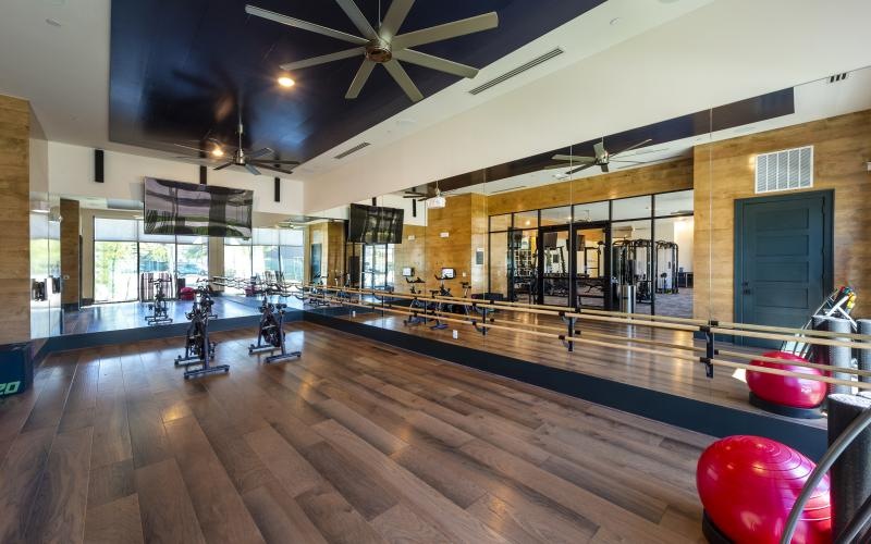 a yoga studio with large mirrors and wood floors